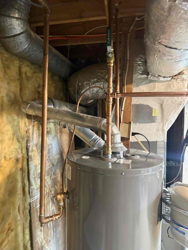 Replaced failed 40-gallon gas water heater that was leaking at the base with new 50-gallon unit in unfinished basement utility area. Disconnected and removed old unit, installed replacement with proper copper piping connections, venting, and code-compliant fittings. Tested all connections for leaks and verified proper operation of new water heater. Replaced failed 40-gallon gas water heater that was leaking at the base with new 50-gallon unit in unfinished basement utility area. Disconnected and removed old unit, installed replacement with proper copper piping connections, venting, and code-compliant fittings. Tested all connections for leaks and verified proper operation of new water heater.