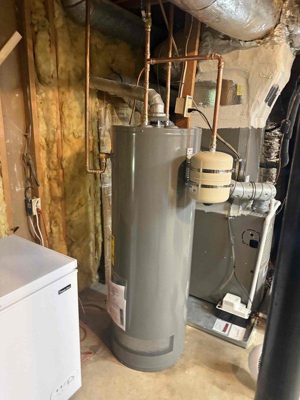 Replaced failed 40-gallon gas water heater that was leaking at the base with new 50-gallon unit in unfinished basement utility area. Disconnected and removed old unit, installed replacement with proper copper piping connections, venting, and code-compliant fittings. Tested all connections for leaks and verified proper operation of new water heater. Replaced failed 40-gallon gas water heater that was leaking at the base with new 50-gallon unit in unfinished basement utility area. Disconnected and removed old unit, installed replacement with proper copper piping connections, venting, and code-compliant fittings. Tested all connections for leaks and verified proper operation of new water heater.