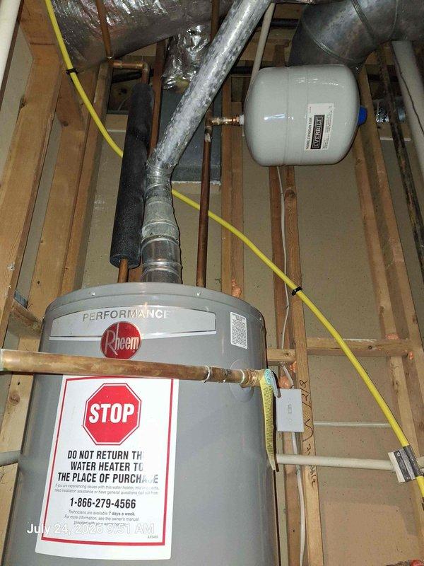 Responded to report of leak in upstairs bathroom occurring during faucet use. Upon investigation, inspected plumbing system including water heater installation, pressure regulation components, and associated piping. Documented existing Rheem Performance water heater with proper warning labels, expansion tank mounting, and connected HVAC ductwork in mechanical space. Verified pressure gauge readings on water system showing measurements within normal operating parameters. Photographed plumbing infrastructure including copper lines with brass fittings, PVC connections, and pressure regulation equipment to establish baseline system conditions for diagnostic purposes. Responded to report of leak in upstairs bathroom occurring during faucet use. Upon investigation, inspected plumbing system including water heater installation, pressure regulation components, and associated piping. Documented existing Rheem Performance water heater with proper warning labels, expansion tank mounting, and connected HVAC ductwork in mechanical space. Verified pressure gauge readings on water system showing measurements within normal operating parameters. Photographed plumbing infrastructure including copper lines with brass fittings, PVC connections, and pressure regulation equipment to establish baseline system conditions for diagnostic purposes.