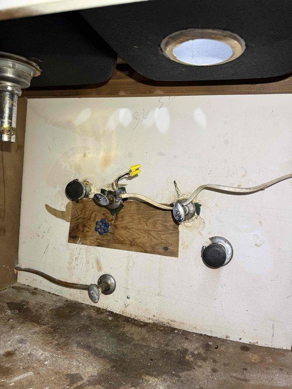 Removed kitchen faucet and capped off hot and cold water supply lines in preparation for customer's kitchen remodeling project. Shut off water supply valves, disconnected faucet from supply lines, removed single-handle chrome faucet from double-basin sink, and properly capped both water lines to prevent leaks during the remodeling phase. Work area left clean and secure, with water supply valves accessible for future reopening when customer is ready to install new faucet upon completion of remodel.