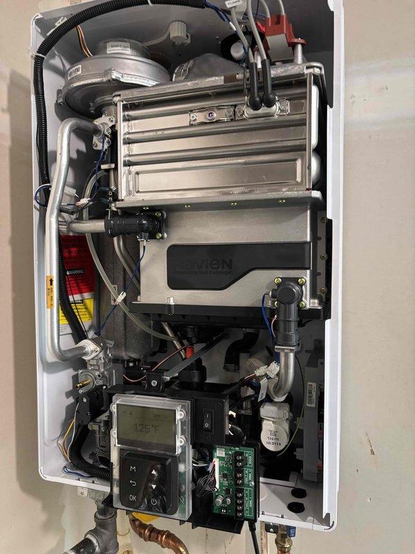 Responded to venting issue code on recently installed Navien tankless water heater. Upon inspection, found improper venting configuration with PVC exhaust pipe installation. Diagnosed fault code related to combustion air flow and exhaust system, adjusted venting components, verified proper clearances, and confirmed unit returned to normal operation with display reading 125°F. Responded to venting issue code on recently installed Navien tankless water heater. Upon inspection, found improper venting configuration with PVC exhaust pipe installation. Diagnosed fault code related to combustion air flow and exhaust system, adjusted venting components, verified proper clearances, and confirmed unit returned to normal operation with display reading 125°F.
