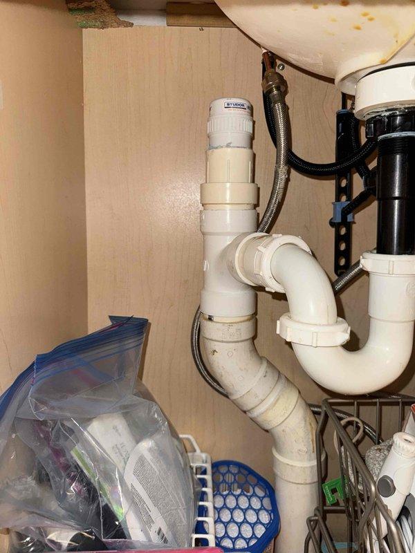 Responded to customer concern regarding sewage odor previously suspected to be mold-related. Conducted thorough inspection of plumbing system, focusing on under-sink drainage assembly and water heater installation area. Documented P-trap configuration, PVC drain lines, supply connections, and water heater piping with photographic evidence for diagnostic purposes. Assessment revealed potential sewage gas infiltration requiring further evaluation of drain trap integrity and venting system. Responded to customer concern regarding sewage odor previously suspected to be mold-related. Conducted thorough inspection of plumbing system, focusing on under-sink drainage assembly and water heater installation area. Documented P-trap configuration, PVC drain lines, supply connections, and water heater piping with photographic evidence for diagnostic purposes. Assessment revealed potential sewage gas infiltration requiring further evaluation of drain trap integrity and venting system.
