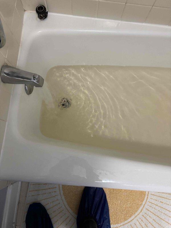 Responded to report of leak under bathroom sink. Upon inspection, found standing water in bathtub with discolored appearance indicating potential drainage issue. Assessed plumbing fixtures including chrome faucet, overflow drain assembly, and main drain. Documented conditions for further evaluation of drainage system and potential blockage causing water accumulation. Responded to report of leak under bathroom sink. Upon inspection, found standing water in bathtub with discolored appearance indicating potential drainage issue. Assessed plumbing fixtures including chrome faucet, overflow drain assembly, and main drain. Documented conditions for further evaluation of drainage system and potential blockage causing water accumulation.