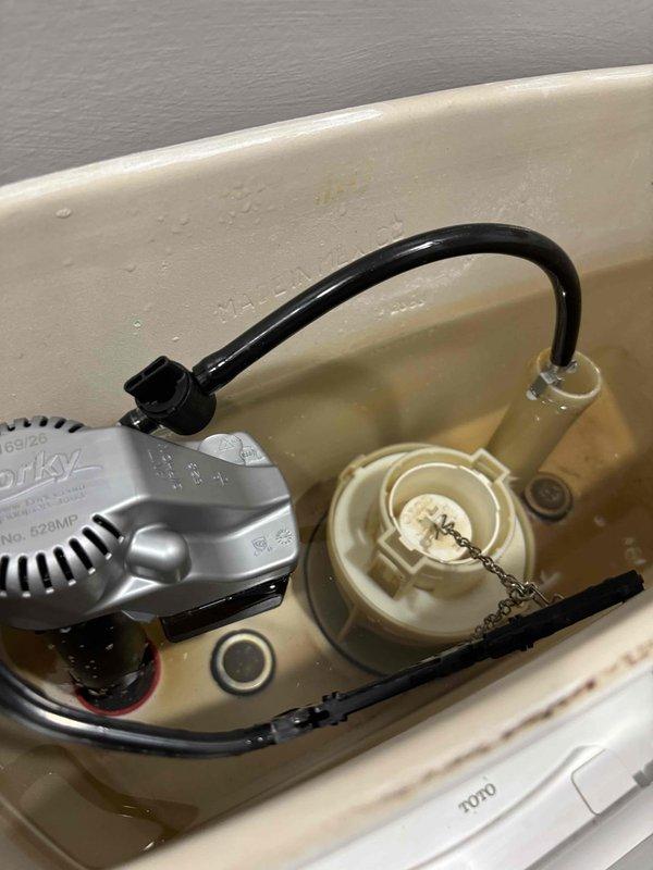 Completed toilet tank repair by replacing defective fill valve and supply line. Installed new Korky brand fill valve assembly with proper float adjustment and connected refill tube to flush valve overflow. Replaced worn supply line to ensure proper water flow and prevent potential leaks. Tested system operation to verify proper tank filling, water level adjustment, and shutoff functionality. All components now operating within manufacturer specifications. Completed toilet tank repair by replacing defective fill valve and supply line. Installed new Korky brand fill valve assembly with proper float adjustment and connected refill tube to flush valve overflow. Replaced worn supply line to ensure proper water flow and prevent potential leaks. Tested system operation to verify proper tank filling, water level adjustment, and shutoff functionality. All components now operating within manufacturer specifications.
