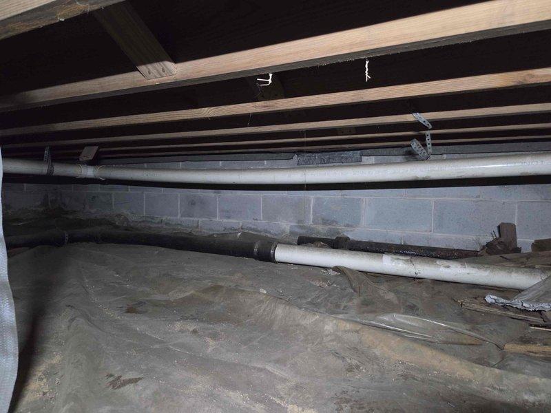 Responded to clogged toilet with backup occurring in laundry room on opposite side of ranch-style home. Accessed crawl space and inspected drainage system, identifying blockage in main drain line. Cleared obstruction in horizontal PVC drain pipe running beneath floor joists, verified proper slope using level, and confirmed drainage flow was restored to both toilet and laundry room fixtures. Responded to clogged toilet with backup occurring in laundry room on opposite side of ranch-style home. Accessed crawl space and inspected drainage system, identifying blockage in main drain line. Cleared obstruction in horizontal PVC drain pipe running beneath floor joists, verified proper slope using level, and confirmed drainage flow was restored to both toilet and laundry room fixtures.