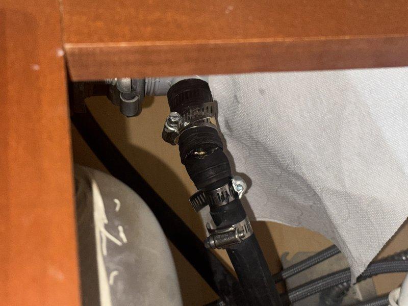 Responded to a plumbing repair call for a broken dishwasher discharge hose that had separated from the garbage disposal connection, causing water leakage. Replaced the damaged flexible discharge hose and secured new connections to both the dishwasher outlet and disposal inlet port using metal hose clamps. Verified all connections were properly sealed and tested the system to ensure no further leaks were present. Responded to a plumbing repair call for a broken dishwasher discharge hose that had separated from the garbage disposal connection, causing water leakage. Replaced the damaged flexible discharge hose and secured new connections to both the dishwasher outlet and disposal inlet port using metal hose clamps. Verified all connections were properly sealed and tested the system to ensure no further leaks were present.