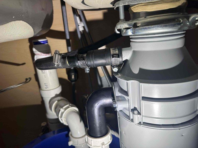 Responded to a plumbing repair call for a broken dishwasher discharge hose that had separated from the garbage disposal connection, causing water leakage. Replaced the damaged flexible discharge hose and secured new connections to both the dishwasher outlet and disposal inlet port using metal hose clamps. Verified all connections were properly sealed and tested the system to ensure no further leaks were present. Responded to a plumbing repair call for a broken dishwasher discharge hose that had separated from the garbage disposal connection, causing water leakage. Replaced the damaged flexible discharge hose and secured new connections to both the dishwasher outlet and disposal inlet port using metal hose clamps. Verified all connections were properly sealed and tested the system to ensure no further leaks were present.