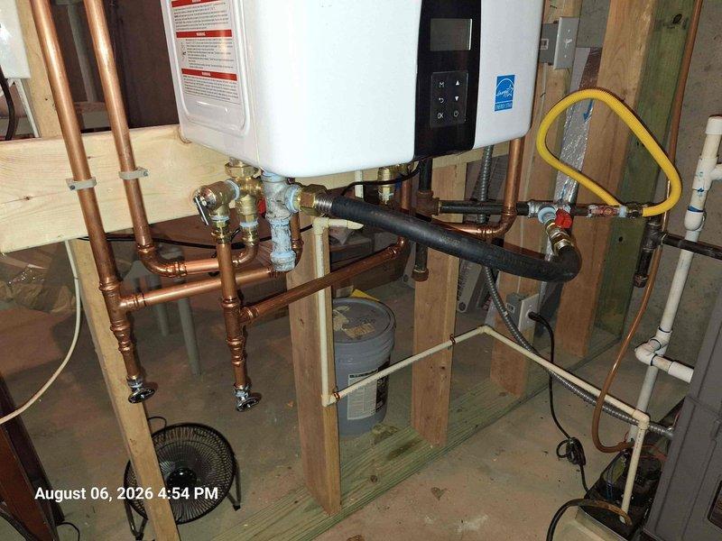 Completed installation of tankless water heater system in utility space, including all required plumbing connections with copper piping, brass valves and fittings, gas line hookup with flexible corrugated tubing, and electrical connections. Unit mounted securely to wall with proper venting and support structure, tested for proper operation and safety compliance. Completed installation of tankless water heater system in utility space, including all required plumbing connections with copper piping, brass valves and fittings, gas line hookup with flexible corrugated tubing, and electrical connections. Unit mounted securely to wall with proper venting and support structure, tested for proper operation and safety compliance.