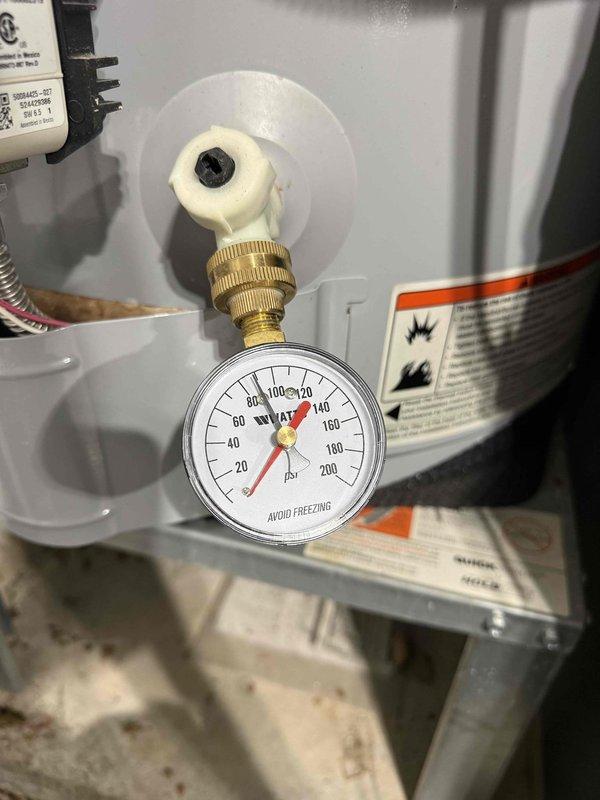 Responded to follow-up call for toilet leaking at base. Upon arrival, performed diagnostic testing of water supply system and plumbing connections in crawl space area. Inspected supply lines, shut-off valves, and pressure conditions using calibration equipment. Documented existing plumbing configuration including copper supply lines, ball valves, and mounting hardware. Photographed pressure gauge readings and overall system layout for service records. Identified moisture presence on vertical piping and assessed condition of all visible connections and support brackets in mechanical space beneath fixture. Responded to follow-up call for toilet leaking at base. Upon arrival, performed diagnostic testing of water supply system and plumbing connections in crawl space area. Inspected supply lines, shut-off valves, and pressure conditions using calibration equipment. Documented existing plumbing configuration including copper supply lines, ball valves, and mounting hardware. Photographed pressure gauge readings and overall system layout for service records. Identified moisture presence on vertical piping and assessed condition of all visible connections and support brackets in mechanical space beneath fixture.
