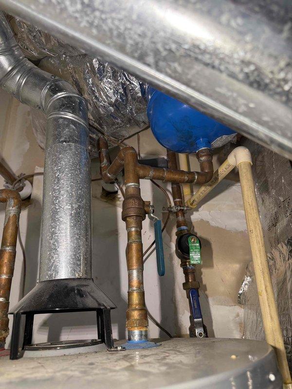 Responded to follow-up call for toilet leaking at base. Upon arrival, performed diagnostic testing of water supply system and plumbing connections in crawl space area. Inspected supply lines, shut-off valves, and pressure conditions using calibration equipment. Documented existing plumbing configuration including copper supply lines, ball valves, and mounting hardware. Photographed pressure gauge readings and overall system layout for service records. Identified moisture presence on vertical piping and assessed condition of all visible connections and support brackets in mechanical space beneath fixture. Responded to follow-up call for toilet leaking at base. Upon arrival, performed diagnostic testing of water supply system and plumbing connections in crawl space area. Inspected supply lines, shut-off valves, and pressure conditions using calibration equipment. Documented existing plumbing configuration including copper supply lines, ball valves, and mounting hardware. Photographed pressure gauge readings and overall system layout for service records. Identified moisture presence on vertical piping and assessed condition of all visible connections and support brackets in mechanical space beneath fixture.