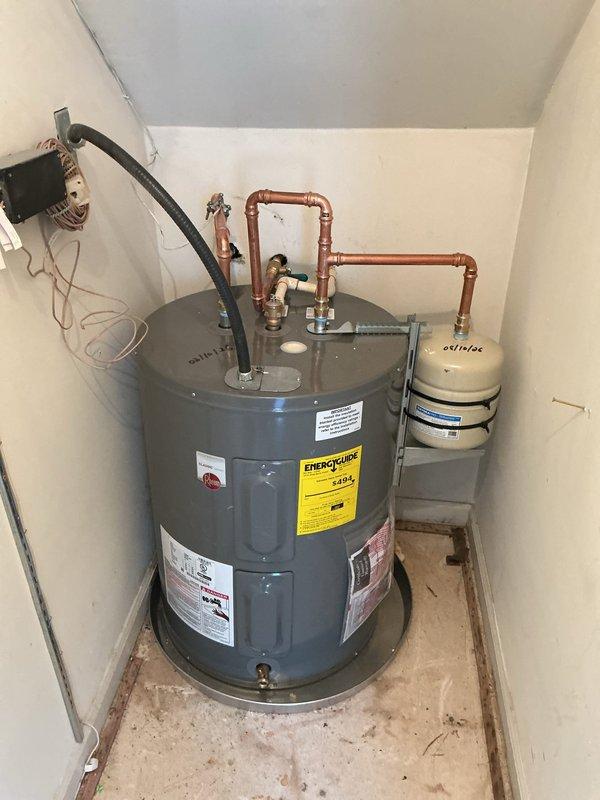 Installed low boy water heater in utility closet with complete plumbing connections. Configured copper piping with proper loop system, installed expansion tank, connected pressure relief valve, and established hot and cold water lines with appropriate shut-off valves. Completed electrical junction box wiring, attached flexible discharge hose, and secured all piping with wall-mounted brackets. System tested and verified operational. Installed low boy water heater in utility closet with complete plumbing connections. Configured copper piping with proper loop system, installed expansion tank, connected pressure relief valve, and established hot and cold water lines with appropriate shut-off valves. Completed electrical junction box wiring, attached flexible discharge hose, and secured all piping with wall-mounted brackets. System tested and verified operational.