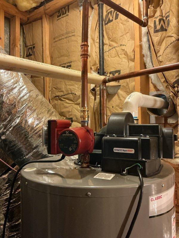 Responded to leak report at gate #7799 near water heater. Upon inspection, identified active leak at copper piping connection point adjacent to Grundfos circulation pump in hydronic heating system. The leak was located at a corroded pipe joint showing significant oxidation and mineral buildup, consistent with age-related deterioration of the copper fitting. Shut down circulation pump, drained affected section of piping, removed compromised fitting, cleaned and prepared pipe ends, and installed new copper coupling using proper soldering techniques. Pressure tested the repaired joint to verify seal integrity, restored system operation, and confirmed no additional leaks present. Inspected surrounding plumbing connections at water heater, expansion tank, and Taco flow control device for any signs of moisture or pending failures. All other components and connections found to be secure and functioning properly at time of service completion. Responded to leak report at gate #7799 near water heater. Upon inspection, identified active leak at copper piping connection point adjacent to Grundfos circulation pump in hydronic heating system. The leak was located at a corroded pipe joint showing significant oxidation and mineral buildup, consistent with age-related deterioration of the copper fitting. Shut down circulation pump, drained affected section of piping, removed compromised fitting, cleaned and prepared pipe ends, and installed new copper coupling using proper soldering techniques. Pressure tested the repaired joint to verify seal integrity, restored system operation, and confirmed no additional leaks present. Inspected surrounding plumbing connections at water heater, expansion tank, and Taco flow control device for any signs of moisture or pending failures. All other components and connections found to be secure and functioning properly at time of service completion.
