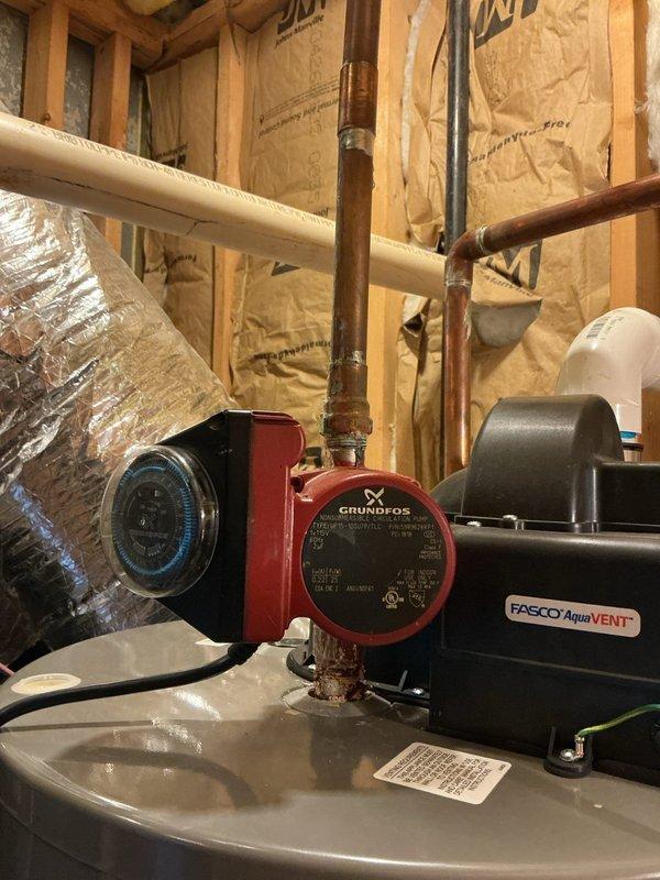 Responded to leak report at gate #7799 near water heater. Upon inspection, identified active leak at copper piping connection point adjacent to Grundfos circulation pump in hydronic heating system. The leak was located at a corroded pipe joint showing significant oxidation and mineral buildup, consistent with age-related deterioration of the copper fitting. Shut down circulation pump, drained affected section of piping, removed compromised fitting, cleaned and prepared pipe ends, and installed new copper coupling using proper soldering techniques. Pressure tested the repaired joint to verify seal integrity, restored system operation, and confirmed no additional leaks present. Inspected surrounding plumbing connections at water heater, expansion tank, and Taco flow control device for any signs of moisture or pending failures. All other components and connections found to be secure and functioning properly at time of service completion. Responded to leak report at gate #7799 near water heater. Upon inspection, identified active leak at copper piping connection point adjacent to Grundfos circulation pump in hydronic heating system. The leak was located at a corroded pipe joint showing significant oxidation and mineral buildup, consistent with age-related deterioration of the copper fitting. Shut down circulation pump, drained affected section of piping, removed compromised fitting, cleaned and prepared pipe ends, and installed new copper coupling using proper soldering techniques. Pressure tested the repaired joint to verify seal integrity, restored system operation, and confirmed no additional leaks present. Inspected surrounding plumbing connections at water heater, expansion tank, and Taco flow control device for any signs of moisture or pending failures. All other components and connections found to be secure and functioning properly at time of service completion.