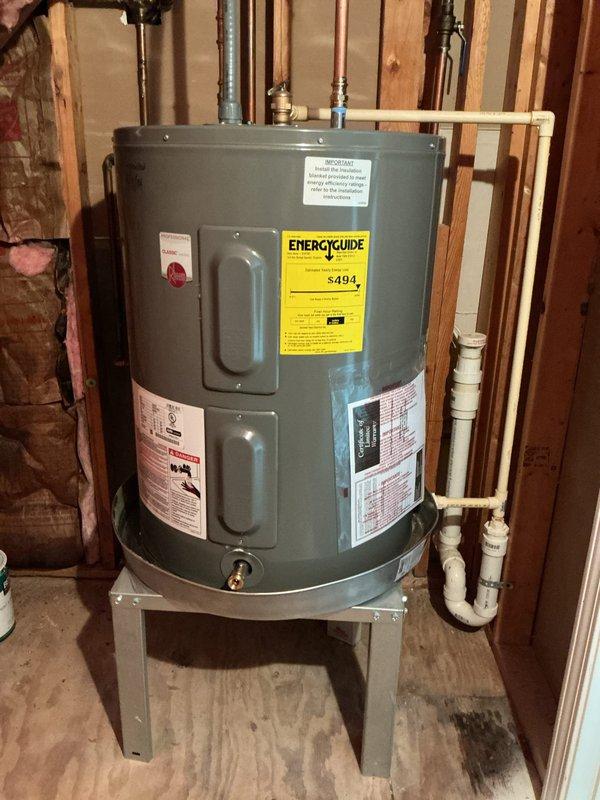 Responded to service call for leaking 38-gallon electric water heater and slow-draining sink. Inspected water heater installation, documented unit condition with photos showing proper mounting on metal stand, copper supply lines, brass fittings, temperature and pressure relief valve, and PVC discharge piping. Assessed plumbing drainage issue at affected sink fixture. Responded to service call for leaking 38-gallon electric water heater and slow-draining sink. Inspected water heater installation, documented unit condition with photos showing proper mounting on metal stand, copper supply lines, brass fittings, temperature and pressure relief valve, and PVC discharge piping. Assessed plumbing drainage issue at affected sink fixture.