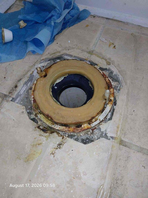 Responded to water leak complaint affecting downstairs bathroom ceiling from bathroom above. Upon investigation, accessed crawl space area and identified active water infiltration patterns on subfloor with multiple circular staining indicating chronic moisture exposure. Inspected upstairs bathroom and discovered compromised toilet flange assembly with deteriorated wax ring seal, rust staining on mounting hardware, and evidence of long-term water seepage around base. Documented conditions showing failed seal allowing wastewater to penetrate tile flooring and migrate through subfloor to ceiling below. Recommended immediate toilet removal, flange replacement, subfloor damage assessment, and proper reinstallation with new wax ring and hardware to eliminate leak source. Responded to water leak complaint affecting downstairs bathroom ceiling from bathroom above. Upon investigation, accessed crawl space area and identified active water infiltration patterns on subfloor with multiple circular staining indicating chronic moisture exposure. Inspected upstairs bathroom and discovered compromised toilet flange assembly with deteriorated wax ring seal, rust staining on mounting hardware, and evidence of long-term water seepage around base. Documented conditions showing failed seal allowing wastewater to penetrate tile flooring and migrate through subfloor to ceiling below. Recommended immediate toilet removal, flange replacement, subfloor damage assessment, and proper reinstallation with new wax ring and hardware to eliminate leak source.