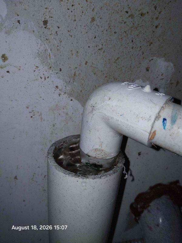 Responded to active leak in bathroom where deteriorated PVC pipe joint was allowing water intrusion. Upon inspection, identified failed elbow connection with visible cracks and material deterioration at the joint. Documented existing conditions showing aging infrastructure with accumulated debris and compromised pipe integrity requiring immediate attention to prevent further water damage. Responded to active leak in bathroom where deteriorated PVC pipe joint was allowing water intrusion. Upon inspection, identified failed elbow connection with visible cracks and material deterioration at the joint. Documented existing conditions showing aging infrastructure with accumulated debris and compromised pipe integrity requiring immediate attention to prevent further water damage.