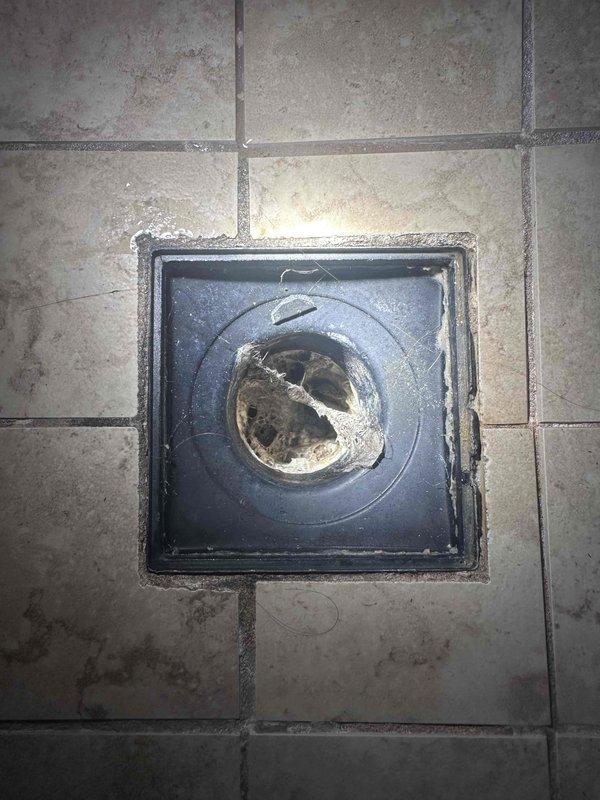 Responded to service call for slow-draining master bathroom shower on second floor. Upon inspection, found significant debris and buildup accumulation in the floor drain opening with visible residue deposits along the drain edges. Successfully cleared the obstruction and restored proper drainage function. Verified system operation and water flow through main plumbing assembly, confirming normal pressure readings and no secondary blockages in the drainage system. Responded to service call for slow-draining master bathroom shower on second floor. Upon inspection, found significant debris and buildup accumulation in the floor drain opening with visible residue deposits along the drain edges. Successfully cleared the obstruction and restored proper drainage function. Verified system operation and water flow through main plumbing assembly, confirming normal pressure readings and no secondary blockages in the drainage system.
