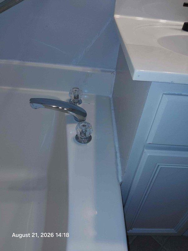 Completed estimate for shower valve and trim replacement in bathroom. Assessed existing chrome faucet fixtures at vanity and exposed shower valve assembly requiring replacement. Documented current conditions including worn countertop area and valve stem access point where wall has been opened to expose plumbing components for upcoming replacement work. Completed estimate for shower valve and trim replacement in bathroom. Assessed existing chrome faucet fixtures at vanity and exposed shower valve assembly requiring replacement. Documented current conditions including worn countertop area and valve stem access point where wall has been opened to expose plumbing components for upcoming replacement work.