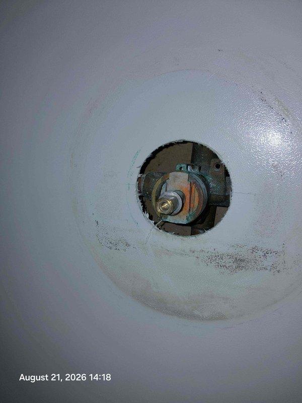 Completed estimate for shower valve and trim replacement in bathroom. Assessed existing chrome faucet fixtures at vanity and exposed shower valve assembly requiring replacement. Documented current conditions including worn countertop area and valve stem access point where wall has been opened to expose plumbing components for upcoming replacement work. Completed estimate for shower valve and trim replacement in bathroom. Assessed existing chrome faucet fixtures at vanity and exposed shower valve assembly requiring replacement. Documented current conditions including worn countertop area and valve stem access point where wall has been opened to expose plumbing components for upcoming replacement work.