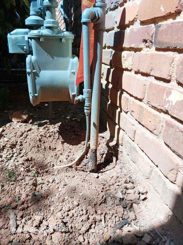 Doraville, GA - Responded to reported gas leak at exterior utility installation. Upon inspection, identified corroded metal piping showing significant surface oxidation and deterioration along vertical run adjacent to gas meter assembly. Performed leak detection testing, isolated affected section, and replaced compromised piping with code-compliant materials to ensure safe gas delivery and eliminate leak hazard. Doraville, GA - Responded to reported gas leak at exterior utility installation. Upon inspection, identified corroded metal piping showing significant surface oxidation and deterioration along vertical run adjacent to gas meter assembly. Performed leak detection testing, isolated affected section, and replaced compromised piping with code-compliant materials to ensure safe gas delivery and eliminate leak hazard.