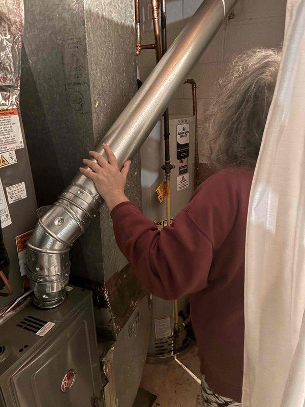 Replaced furnace vent pipe to common connector in residential basement utility area. Navigated attic crawl space with loose-fill insulation to access existing ductwork, removed deteriorated venting, and installed new metallic vent pipe with proper elbow joint connections to ensure safe exhaust ventilation from furnace to common venting system. Replaced furnace vent pipe to common connector in residential basement utility area. Navigated attic crawl space with loose-fill insulation to access existing ductwork, removed deteriorated venting, and installed new metallic vent pipe with proper elbow joint connections to ensure safe exhaust ventilation from furnace to common venting system.