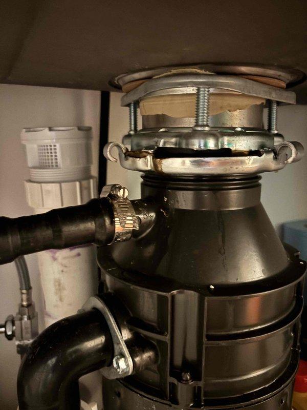Responded to service call for leak detection and repair at kitchen sink plumbing system. Upon inspection, located leak source in under-sink plumbing assembly involving garbage disposal unit and associated drainage piping. Examined PVC P-trap configuration, disposal mounting assembly, and dishwasher drain line connections. Identified compromised connection points and addressed leak at disposal unit interface. Tightened mounting hardware, verified proper seal at sink flange connection, and inspected all PVC joints and hose clamp connections for integrity. Tested system operation and confirmed leak was successfully repaired with no further water discharge detected. Responded to service call for leak detection and repair at kitchen sink plumbing system. Upon inspection, located leak source in under-sink plumbing assembly involving garbage disposal unit and associated drainage piping. Examined PVC P-trap configuration, disposal mounting assembly, and dishwasher drain line connections. Identified compromised connection points and addressed leak at disposal unit interface. Tightened mounting hardware, verified proper seal at sink flange connection, and inspected all PVC joints and hose clamp connections for integrity. Tested system operation and confirmed leak was successfully repaired with no further water discharge detected.