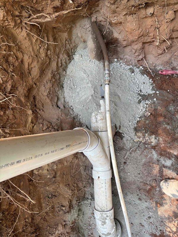 Completed installation of new cleanout fitting for residential plumbing system. Coordinated 811 utility locate prior to excavation. Excavated trench in clay soil to access existing sewer line, installed white PVC cleanout assembly with appropriate fittings and connections, backfilled trench with gravel bedding for proper pipe support, and restored work area. Cleanout provides accessible point for future maintenance and clearing of main drain line serving bathroom fixtures. Completed installation of new cleanout fitting for residential plumbing system. Coordinated 811 utility locate prior to excavation. Excavated trench in clay soil to access existing sewer line, installed white PVC cleanout assembly with appropriate fittings and connections, backfilled trench with gravel bedding for proper pipe support, and restored work area. Cleanout provides accessible point for future maintenance and clearing of main drain line serving bathroom fixtures.