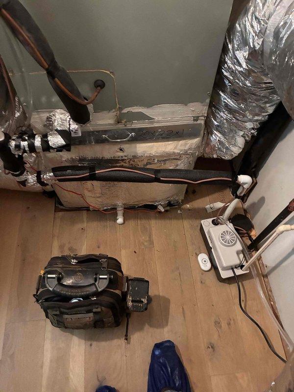 Inspected condensate pump and associated HVAC system in attic installation. Documented Empire air handler unit with refrigerant lines, flexible ductwork, PVC condensate drain lines, and wall-mounted condensate pump to verify proper operation and identify any drainage concerns. Inspected condensate pump and associated HVAC system in attic installation. Documented Empire air handler unit with refrigerant lines, flexible ductwork, PVC condensate drain lines, and wall-mounted condensate pump to verify proper operation and identify any drainage concerns.