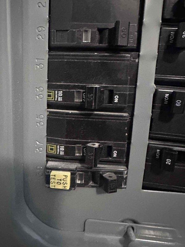 Responded to follow-up service call for ongoing hot water issue. Inspected electrical panel serving water heating equipment and documented current breaker configuration. Panel contains dual 30-amp double-pole breakers with visible wear and rust on enclosure. Verified breaker positions and captured detailed photos of panel interior, breaker labels, and circuit identification for further diagnostic evaluation and potential electrical system upgrades. Responded to follow-up service call for ongoing hot water issue. Inspected electrical panel serving water heating equipment and documented current breaker configuration. Panel contains dual 30-amp double-pole breakers with visible wear and rust on enclosure. Verified breaker positions and captured detailed photos of panel interior, breaker labels, and circuit identification for further diagnostic evaluation and potential electrical system upgrades.