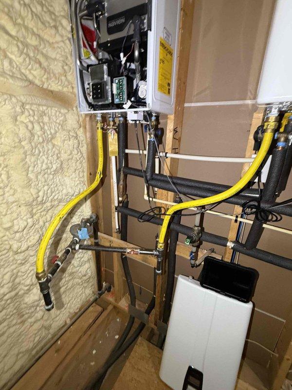 Responded to error code 003 on Navien tankless water heater. Inspected unit and associated components including gas lines, electrical connections, and plumbing fixtures in mechanical room during active construction phase. Verified proper installation of yellow flexible gas lines, copper supply piping with shut-off valves, and electrical panel connections to resolve intermittent operation issue requiring manual reset. Responded to error code 003 on Navien tankless water heater. Inspected unit and associated components including gas lines, electrical connections, and plumbing fixtures in mechanical room during active construction phase. Verified proper installation of yellow flexible gas lines, copper supply piping with shut-off valves, and electrical panel connections to resolve intermittent operation issue requiring manual reset.