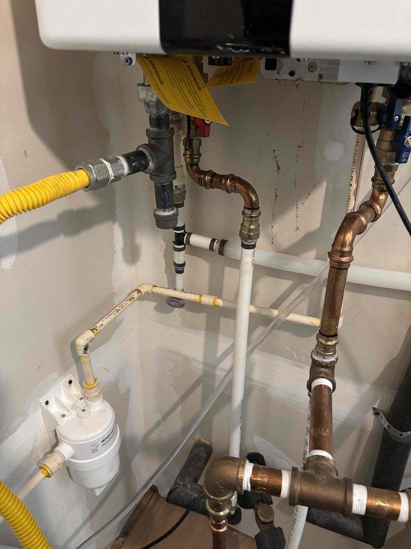 Replaced temperature and pressure relief valve discharge line on water heater with updated piping configuration. Installed Navien condensate neutralizer system to treat acidic condensate drainage from high-efficiency heating equipment, including proper media chamber setup and overflow protection. Completed all plumbing connections using appropriate copper and PVC pipe materials, ensuring proper drainage flow and system integration with existing gas and water supply lines. Replaced temperature and pressure relief valve discharge line on water heater with updated piping configuration. Installed Navien condensate neutralizer system to treat acidic condensate drainage from high-efficiency heating equipment, including proper media chamber setup and overflow protection. Completed all plumbing connections using appropriate copper and PVC pipe materials, ensuring proper drainage flow and system integration with existing gas and water supply lines.