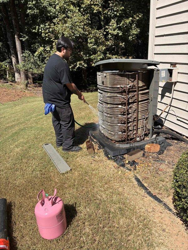 Roswell, GA - Performed comprehensive HVAC maintenance on residential air conditioning system in response to excessive runtime concerns. Removed outdoor condenser unit casing to inspect internal coil assembly, which revealed debris accumulation between fin layers affecting heat transfer efficiency. Cleaned condenser coils, verified refrigerant levels and pressures, checked airflow settings, and confirmed proper system operation to address runtime issues and restore optimal cooling performance. Roswell, GA - Performed comprehensive HVAC maintenance on residential air conditioning system in response to excessive runtime concerns. Removed outdoor condenser unit casing to inspect internal coil assembly, which revealed debris accumulation between fin layers affecting heat transfer efficiency. Cleaned condenser coils, verified refrigerant levels and pressures, checked airflow settings, and confirmed proper system operation to address runtime issues and restore optimal cooling performance.
