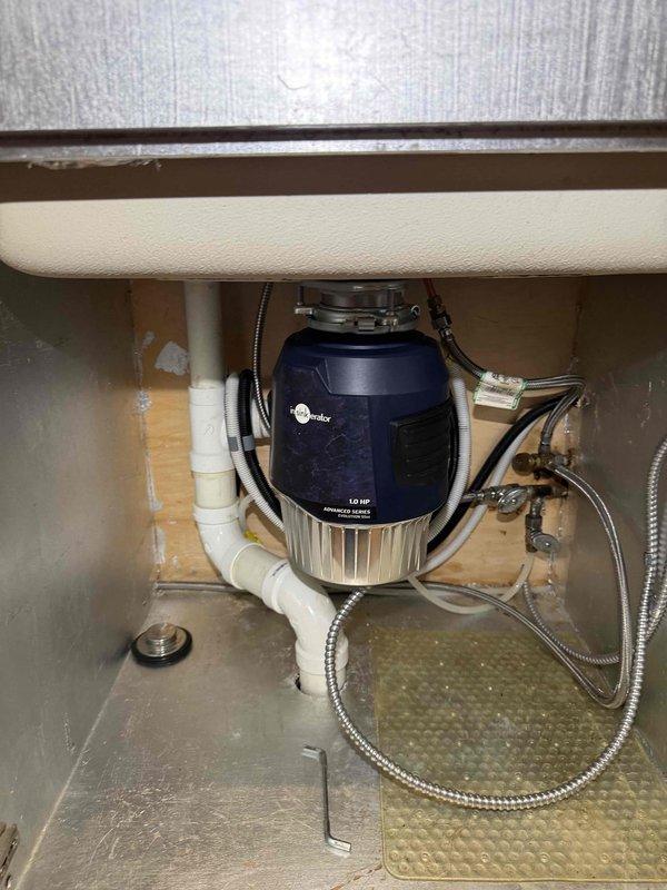 Completed replacement of two garbage disposal units in kitchen sink cabinets. Removed existing disposals and installed new InSinkErator 1.0 HP garbage disposal units beneath sink basins, connecting to existing white PVC drain lines and verifying proper electrical connections. All plumbing connections secured and tested for leaks, with braided supply lines and shut-off valves confirmed operational. Completed replacement of two garbage disposal units in kitchen sink cabinets. Removed existing disposals and installed new InSinkErator 1.0 HP garbage disposal units beneath sink basins, connecting to existing white PVC drain lines and verifying proper electrical connections. All plumbing connections secured and tested for leaks, with braided supply lines and shut-off valves confirmed operational.