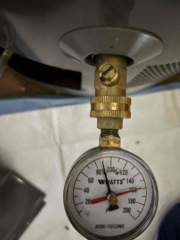 Responded to service call for water heater not producing hot water. Upon arrival, performed diagnostic inspection of the unit and associated components. Inspected gas supply line connections, pressure relief valve, and temperature-pressure gauge reading. Documented current system configuration including venting setup and gas line installation with flexible connector. Verified water supply connections and checked system pressure using installed gauge. Discussed findings with customer regarding existing estimate for power vent water heater replacement currently on file. Photographed current installation conditions showing gas line configuration with flexible yellow corrugated connector, pressure gauge mounted on unit displaying proper scale markings, and black vent pipe with red valve fitting. Advised customer of system status and confirmed awareness of pending replacement estimate for power vent unit conversion. Responded to service call for water heater not producing hot water. Upon arrival, performed diagnostic inspection of the unit and associated components. Inspected gas supply line connections, pressure relief valve, and temperature-pressure gauge reading. Documented current system configuration including venting setup and gas line installation with flexible connector. Verified water supply connections and checked system pressure using installed gauge. Discussed findings with customer regarding existing estimate for power vent water heater replacement currently on file. Photographed current installation conditions showing gas line configuration with flexible yellow corrugated connector, pressure gauge mounted on unit displaying proper scale markings, and black vent pipe with red valve fitting. Advised customer of system status and confirmed awareness of pending replacement estimate for power vent unit conversion.