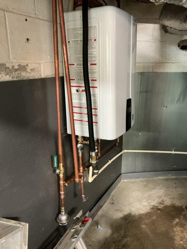 Installed Navien tankless water heater in basement mechanical room. Completed all plumbing connections including copper supply lines with brass fittings and shutoff valves, configured proper venting system, and tested unit for proper operation. Installed Navien tankless water heater in basement mechanical room. Completed all plumbing connections including copper supply lines with brass fittings and shutoff valves, configured proper venting system, and tested unit for proper operation.