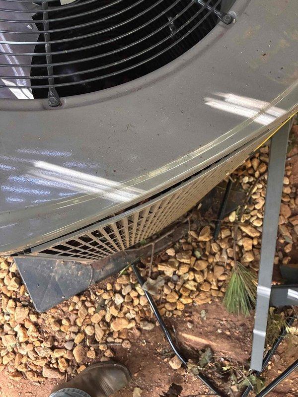 Responded to service call for AC unit inspection following tree damage. Upon arrival, conducted thorough visual assessment of outdoor condensing unit and accessible ductwork components. Examined exterior unit housing, fan assembly, and surrounding installation area for impact damage, structural compromise, or debris intrusion. Inspected indoor ductwork sections including flexible ducting and rigid purple-wrapped insulated runs for displacement, crushing, or separation at connection points. Documented current condition of all accessible HVAC components through comprehensive photography for insurance and repair assessment purposes. Unit remains in place on concrete pad with no immediate visible catastrophic damage to major components, though further diagnostic testing recommended before operation. Responded to service call for AC unit inspection following tree damage. Upon arrival, conducted thorough visual assessment of outdoor condensing unit and accessible ductwork components. Examined exterior unit housing, fan assembly, and surrounding installation area for impact damage, structural compromise, or debris intrusion. Inspected indoor ductwork sections including flexible ducting and rigid purple-wrapped insulated runs for displacement, crushing, or separation at connection points. Documented current condition of all accessible HVAC components through comprehensive photography for insurance and repair assessment purposes. Unit remains in place on concrete pad with no immediate visible catastrophic damage to major components, though further diagnostic testing recommended before operation.
