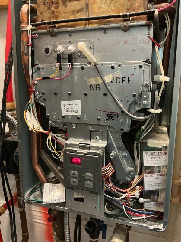 Responded to service call for InstaHot unit experiencing beeping alarm and no hot water production. Upon inspection, found control board displaying error code 195 on digital readout. Accessed internal cabinet to examine VCFF NG control board and associated electrical connections. Inspected all wire harnesses, terminals, and safety circuits for proper operation. Evaluated upstream plumbing connections including copper supply lines, brass valve assembly, and associated PEX connections at water inlet. Diagnosed issue, documented system configuration with photographs, and assessed control board functionality and water flow path to determine cause of alarm condition and loss of hot water delivery. Responded to service call for InstaHot unit experiencing beeping alarm and no hot water production. Upon inspection, found control board displaying error code 195 on digital readout. Accessed internal cabinet to examine VCFF NG control board and associated electrical connections. Inspected all wire harnesses, terminals, and safety circuits for proper operation. Evaluated upstream plumbing connections including copper supply lines, brass valve assembly, and associated PEX connections at water inlet. Diagnosed issue, documented system configuration with photographs, and assessed control board functionality and water flow path to determine cause of alarm condition and loss of hot water delivery.