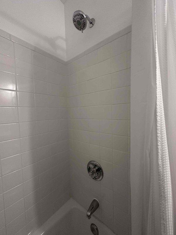 Installed complete chrome shower trim assembly in tiled bathroom, including wall-mounted temperature control valve, tub spout, and overhead showerhead. All fixtures properly secured to wall-mounted plumbing connections and tested for proper operation and water flow. Installed complete chrome shower trim assembly in tiled bathroom, including wall-mounted temperature control valve, tub spout, and overhead showerhead. All fixtures properly secured to wall-mounted plumbing connections and tested for proper operation and water flow.