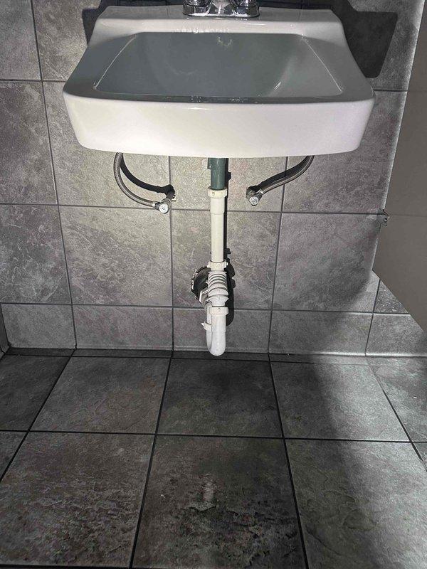Responded to service call for leaking urinal and loose toilet fixtures in commercial restroom facilities. Conducted comprehensive inspection of both bathroom areas, examining all plumbing fixtures including wall-mounted urinals, floor-mounted toilets, and sink assemblies. Documented existing conditions through photographic evidence showing exposed plumbing components, supply lines, drain assemblies, and fixture mounting systems to provide visual record of installation status and identify sources of reported issues. Responded to service call for leaking urinal and loose toilet fixtures in commercial restroom facilities. Conducted comprehensive inspection of both bathroom areas, examining all plumbing fixtures including wall-mounted urinals, floor-mounted toilets, and sink assemblies. Documented existing conditions through photographic evidence showing exposed plumbing components, supply lines, drain assemblies, and fixture mounting systems to provide visual record of installation status and identify sources of reported issues.