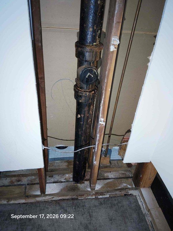 Replaced severely corroded black iron waste pipe and fittings showing extensive rust damage and deterioration at joints. Installed new PVC drainage pipe with proper rubber coupling and stainless steel clamps to ensure secure, leak-free connection between existing plumbing system and new components. Addressed moisture damage concerns in surrounding wooden framing and verified proper drainage flow through updated system. Replaced severely corroded black iron waste pipe and fittings showing extensive rust damage and deterioration at joints. Installed new PVC drainage pipe with proper rubber coupling and stainless steel clamps to ensure secure, leak-free connection between existing plumbing system and new components. Addressed moisture damage concerns in surrounding wooden framing and verified proper drainage flow through updated system.