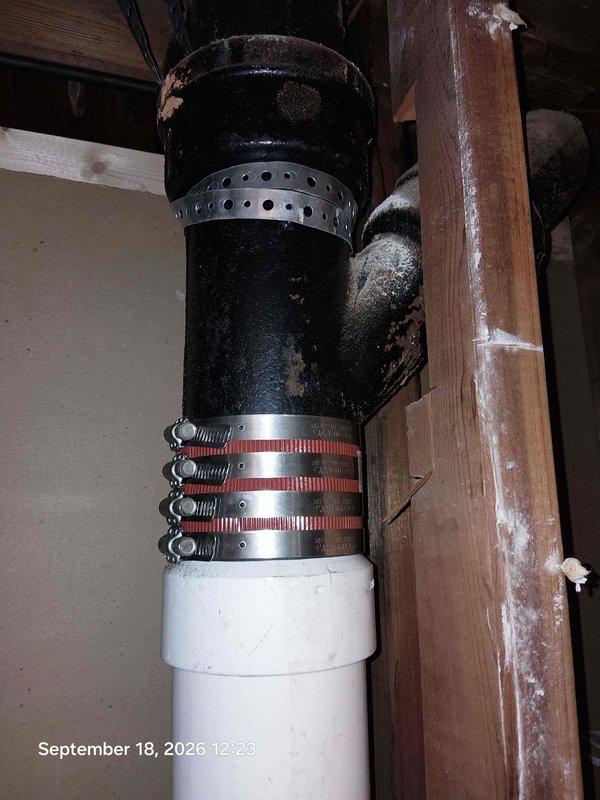 Replaced severely corroded black iron waste pipe and fittings showing extensive rust damage and deterioration at joints. Installed new PVC drainage pipe with proper rubber coupling and stainless steel clamps to ensure secure, leak-free connection between existing plumbing system and new components. Addressed moisture damage concerns in surrounding wooden framing and verified proper drainage flow through updated system. Replaced severely corroded black iron waste pipe and fittings showing extensive rust damage and deterioration at joints. Installed new PVC drainage pipe with proper rubber coupling and stainless steel clamps to ensure secure, leak-free connection between existing plumbing system and new components. Addressed moisture damage concerns in surrounding wooden framing and verified proper drainage flow through updated system.