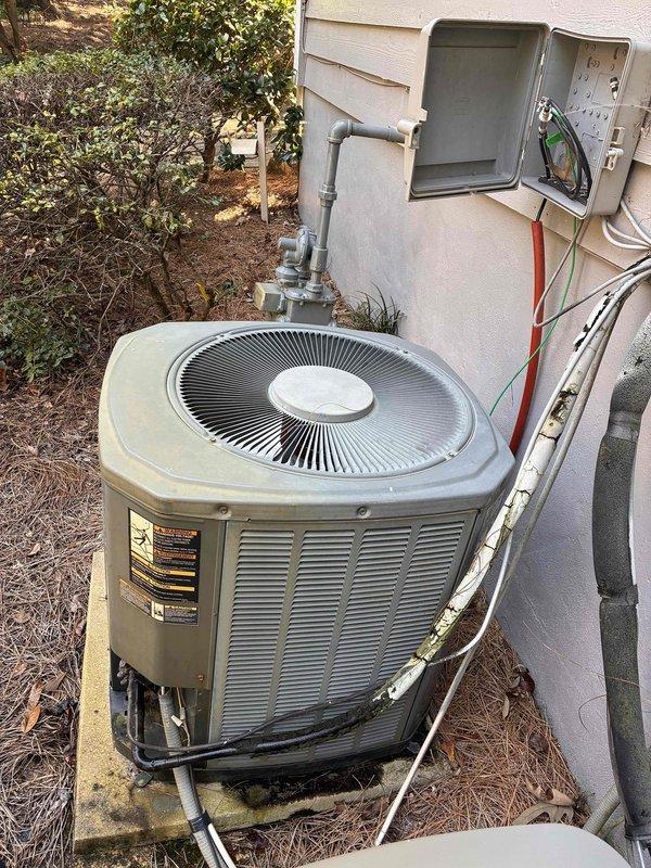# Complete HVAC Maintenance
Performed comprehensive HVAC system maintenance on residential heating and cooling equipment. Conducted thorough inspection of gas furnace assembly, documenting extensive rust and corrosion present on heat exchanger components, horizontal metal plates, and internal piping. Observed deterioration on metallic surfaces with significant oxidation throughout the unit. Inspected blower motor assembly, flame sensors, ignition elements, and electrical connections. Noted disorganized wiring in lower cabinet section requiring attention. Examined outdoor condensing unit positioned on concrete pad, verifying proper operation of fan assembly and ventilation. Inspected electrical disconnect box and associated conduit connections running to exterior wall mount. Documented overall system condition including signs of age, wear, and component degradation. Provided photographic documentation of interior furnace condition and exterior condensing unit installation for customer # Complete HVAC Maintenance
Performed comprehensive HVAC system maintenance on residential heating and cooling equipment. Conducted thorough inspection of gas furnace assembly, documenting extensive rust and corrosion present on heat exchanger components, horizontal metal plates, and internal piping. Observed deterioration on metallic surfaces with significant oxidation throughout the unit. Inspected blower motor assembly, flame sensors, ignition elements, and electrical connections. Noted disorganized wiring in lower cabinet section requiring attention. Examined outdoor condensing unit positioned on concrete pad, verifying proper operation of fan assembly and ventilation. Inspected electrical disconnect box and associated conduit connections running to exterior wall mount. Documented overall system condition including signs of age, wear, and component degradation. Provided photographic documentation of interior furnace condition and exterior condensing unit installation for customer