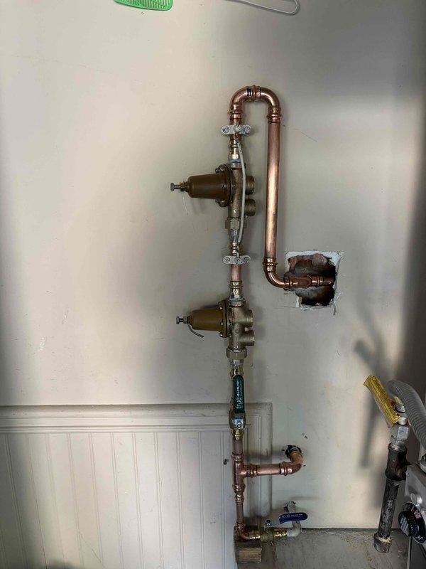Replaced high-pressure water regulator on main supply line. Installed new brass pressure-reducing valve with copper piping connections, ensuring proper water pressure regulation throughout the building. System tested and verified operational with no leaks detected. Replaced high-pressure water regulator on main supply line. Installed new brass pressure-reducing valve with copper piping connections, ensuring proper water pressure regulation throughout the building. System tested and verified operational with no leaks detected.