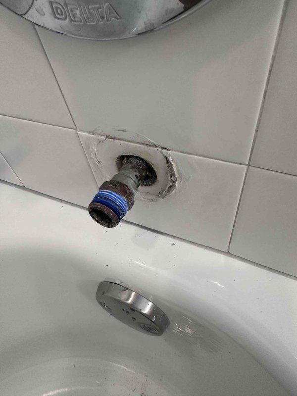 Completed bathroom plumbing repair involving Delta shower fixture installation. Addressed exposed pipe stub with blue threaded adapter connection through tiled wall, securing proper fit for shower assembly. Inspected and verified bathtub drain assembly functionality, including chrome overflow cover plate and mounting hardware. All plumbing connections tested and confirmed operational upon completion. Completed bathroom plumbing repair involving Delta shower fixture installation. Addressed exposed pipe stub with blue threaded adapter connection through tiled wall, securing proper fit for shower assembly. Inspected and verified bathtub drain assembly functionality, including chrome overflow cover plate and mounting hardware. All plumbing connections tested and confirmed operational upon completion.