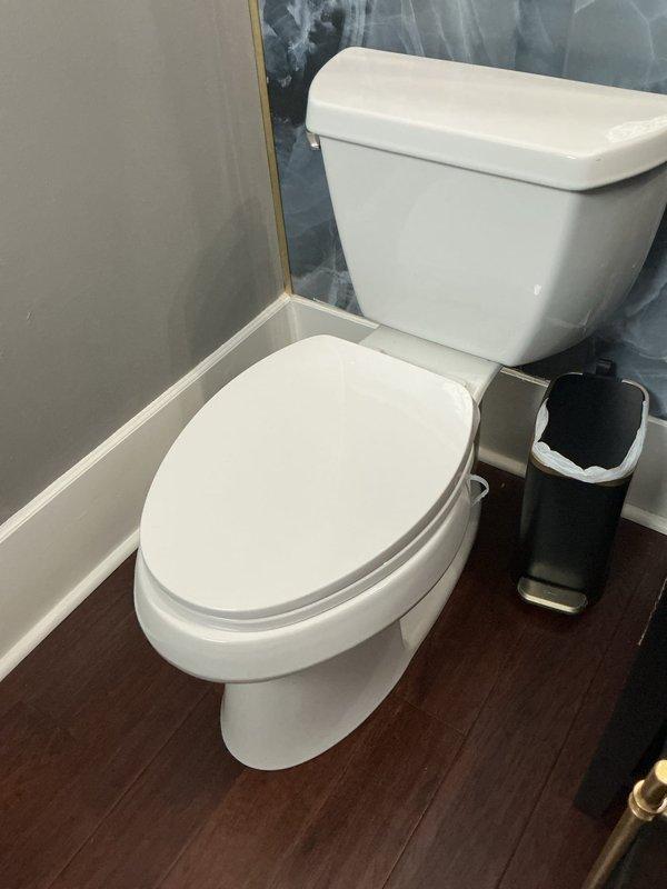 Roswell, GA - Responded to complaint of sewage odor emanating from floor area at base of powder room toilet, with odor intensifying during hot weather and periods of infrequent use. Performed visual inspection of toilet installation, surrounding flooring, and wall connections. Documented conditions with photographs showing standard two-piece toilet installation on wood-look plank flooring with proper baseboard trim and wall finishes. No visible leaks, water damage, or structural issues observed during inspection. Roswell, GA - Responded to complaint of sewage odor emanating from floor area at base of powder room toilet, with odor intensifying during hot weather and periods of infrequent use. Performed visual inspection of toilet installation, surrounding flooring, and wall connections. Documented conditions with photographs showing standard two-piece toilet installation on wood-look plank flooring with proper baseboard trim and wall finishes. No visible leaks, water damage, or structural issues observed during inspection.