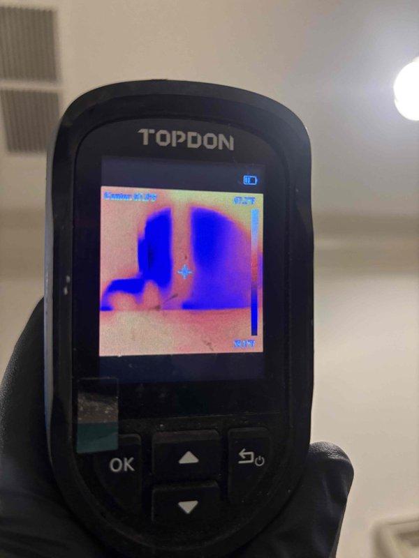 Responded to report of leak in wall at residential property. Upon arrival, conducted visual inspection of utility installation area revealing multiple plumbing connections including PVC piping and flexible corrugated metallic tubing. Utilized TOPDON thermal imaging camera to identify temperature anomalies and moisture patterns behind wall surfaces and around pipe connections. Thermal scan detected temperature variations indicating potential leak location near plumbing assembly. Documented findings with photographs showing utility room configuration including gas line with safety labeling, electrical components, and plumbing infrastructure. Inspection revealed flexible connector loop and associated PVC pipe runs requiring further evaluation. Thermal imaging confirmed presence of moisture-related temperature differential consistent with active water leak. Provided photographic documentation of affected area and thermal imaging results for repair assessment. Responded to report of leak in wall at residential property. Upon arrival, conducted visual inspection of utility installation area revealing multiple plumbing connections including PVC piping and flexible corrugated metallic tubing. Utilized TOPDON thermal imaging camera to identify temperature anomalies and moisture patterns behind wall surfaces and around pipe connections. Thermal scan detected temperature variations indicating potential leak location near plumbing assembly. Documented findings with photographs showing utility room configuration including gas line with safety labeling, electrical components, and plumbing infrastructure. Inspection revealed flexible connector loop and associated PVC pipe runs requiring further evaluation. Thermal imaging confirmed presence of moisture-related temperature differential consistent with active water leak. Provided photographic documentation of affected area and thermal imaging results for repair assessment.