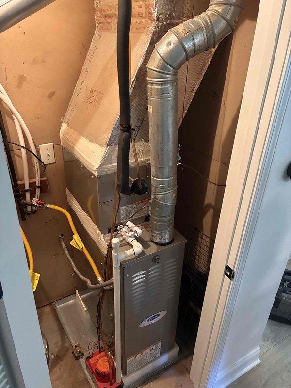 Responded to noise complaint regarding residential HVAC system. Upon inspection, identified furnace unit in utility closet and examined attic ductwork installation. Documented system configuration including forced-air furnace, metallic ductwork, refrigerant lines, and flexible duct runs in attic space with loose-fill insulation. Responded to noise complaint regarding residential HVAC system. Upon inspection, identified furnace unit in utility closet and examined attic ductwork installation. Documented system configuration including forced-air furnace, metallic ductwork, refrigerant lines, and flexible duct runs in attic space with loose-fill insulation.