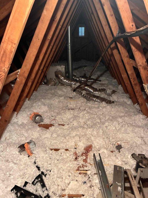 Responded to noise complaint regarding residential HVAC system. Upon inspection, identified furnace unit in utility closet and examined attic ductwork installation. Documented system configuration including forced-air furnace, metallic ductwork, refrigerant lines, and flexible duct runs in attic space with loose-fill insulation. Responded to noise complaint regarding residential HVAC system. Upon inspection, identified furnace unit in utility closet and examined attic ductwork installation. Documented system configuration including forced-air furnace, metallic ductwork, refrigerant lines, and flexible duct runs in attic space with loose-fill insulation.