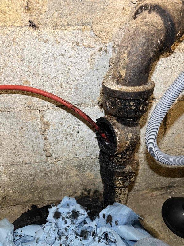 Responded to laundry room leak complaint and conducted thorough inspection of plumbing system. Identified severely corroded metal pipe assembly with T-junction configuration showing extensive rust, surface degradation, and deterioration at threaded connection points. Performed video inspection of associated drain line, revealing buildup of sediment deposits and deteriorated pipe interior conditions at approximately 31 feet 9 inches into the system. Documented all findings with photographic evidence showing compromised pipe integrity and accumulated debris within drainage system requiring attention. Responded to laundry room leak complaint and conducted thorough inspection of plumbing system. Identified severely corroded metal pipe assembly with T-junction configuration showing extensive rust, surface degradation, and deterioration at threaded connection points. Performed video inspection of associated drain line, revealing buildup of sediment deposits and deteriorated pipe interior conditions at approximately 31 feet 9 inches into the system. Documented all findings with photographic evidence showing compromised pipe integrity and accumulated debris within drainage system requiring attention.