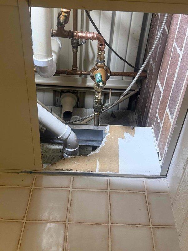 Performed pressure diagnostic evaluation on building water system and identified plumbing issues requiring water shutdown to the entire building. Inspected bathroom plumbing connections including toilet supply lines, shut-off valves, and flexible braided metal water supply components. Examined mechanical closet containing water distribution infrastructure with copper piping, brass pressure valves, PVC drainage lines, and associated fittings. Documented conditions of plumbing system through photographic evidence showing toilet fixture connections, decorative tile flooring, wall-mounted shut-off valves, and utility compartment containing water supply lines, pressure regulation components, and drainage pan assembly. Coordinated with building management regarding system shutdown and diagnostic findings. Performed pressure diagnostic evaluation on building water system and identified plumbing issues requiring water shutdown to the entire building. Inspected bathroom plumbing connections including toilet supply lines, shut-off valves, and flexible braided metal water supply components. Examined mechanical closet containing water distribution infrastructure with copper piping, brass pressure valves, PVC drainage lines, and associated fittings. Documented conditions of plumbing system through photographic evidence showing toilet fixture connections, decorative tile flooring, wall-mounted shut-off valves, and utility compartment containing water supply lines, pressure regulation components, and drainage pan assembly. Coordinated with building management regarding system shutdown and diagnostic findings.